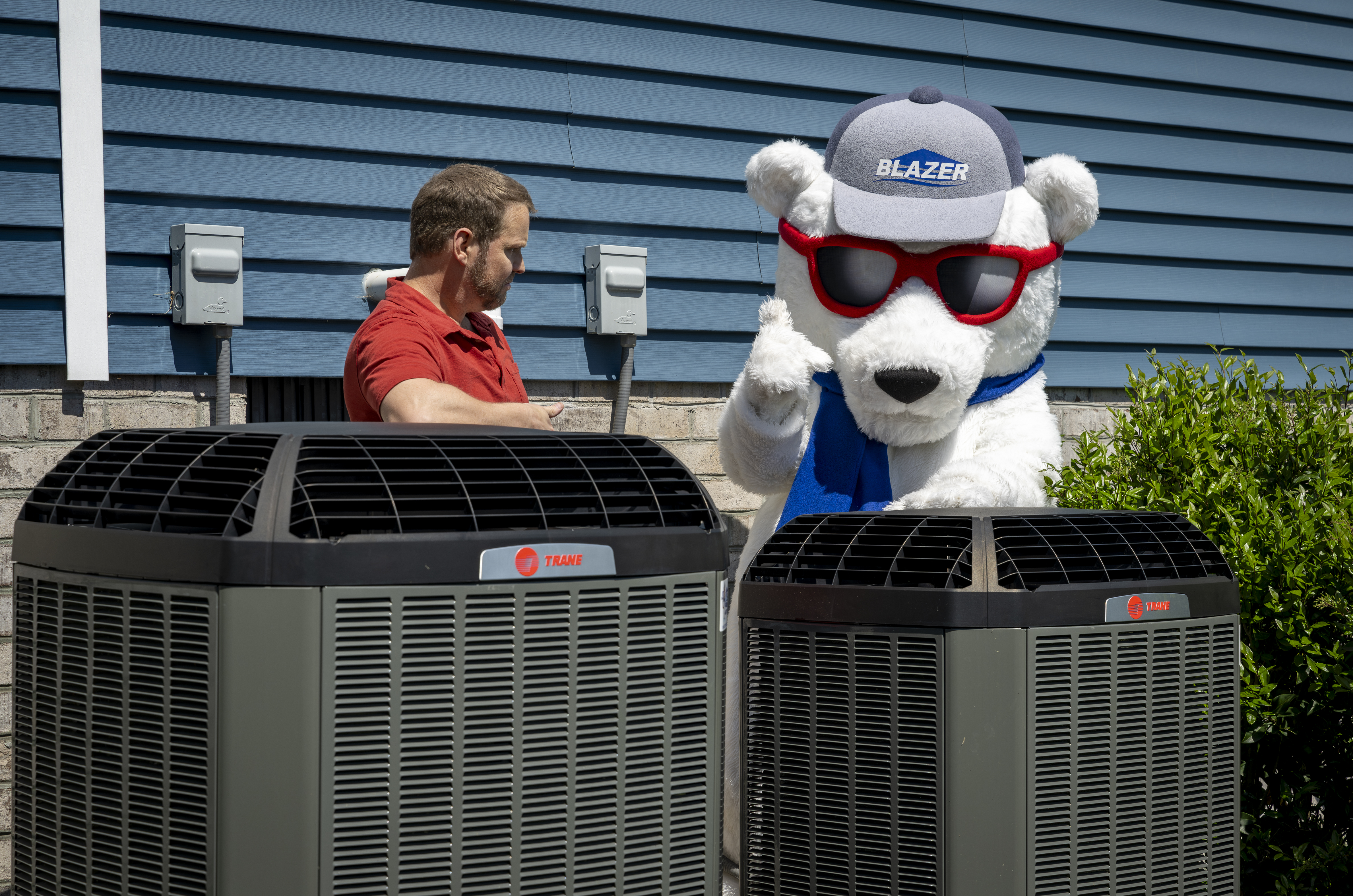 Blaze the Bear and tech looking at ac units